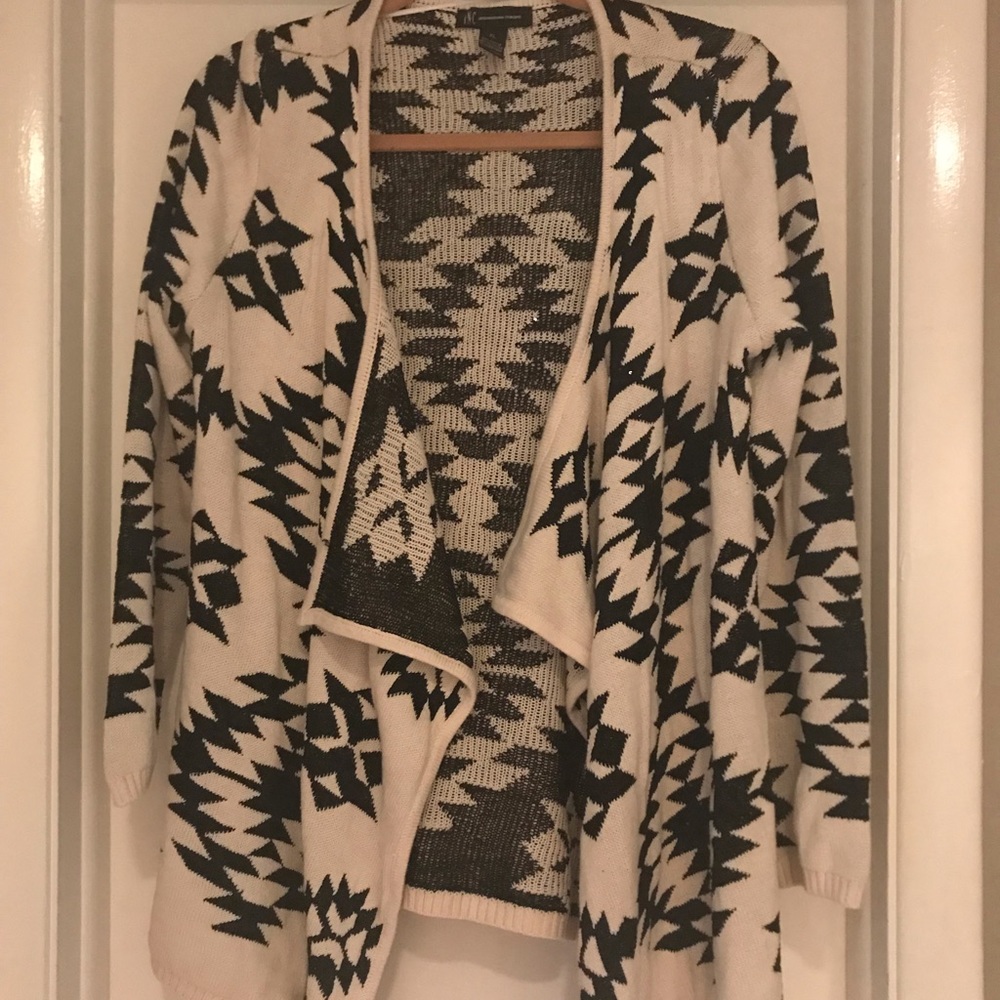 Open front cream and black cardigan with sequins.